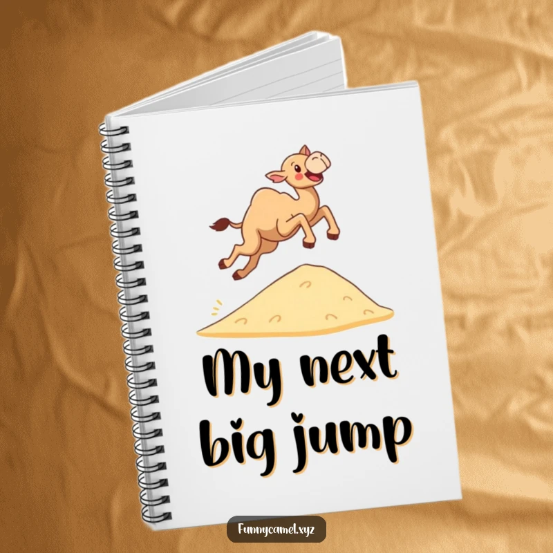 Funny determined camel leaping joyfully over a small sand dune, showcased on a notebook cover for inspired planning.